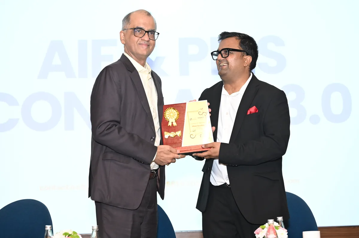 Certificate of appreciation being presented to a speaker on stage