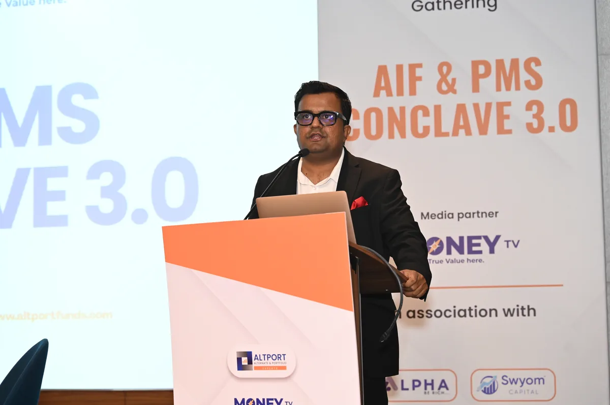 Speaker addressing the audience from the podium at Conclave 3.0